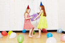 Girls fighting over birthday gift — Stock Photo