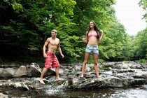 Couple standing by river — Stock Photo