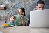 Family working at breakfast table — Stock Photo