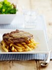 Steak with french fries and salad — Stock Photo
