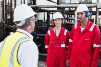 Workers talking at chemical plant — Stock Photo