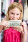 Portrait of girl holding dollar bill — Stock Photo