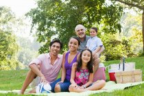 Three generation family at picnic in park, portrait — Stock Photo