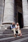 Mature couple sitting on stairs — Stock Photo