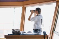Officer looking through binoculars — Stock Photo
