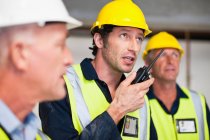 Workers using walkie talkie on site — Stock Photo