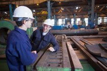 Workers talking in steel forge — Stock Photo