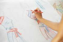 Female hand drawing fashion designs — Stock Photo