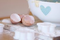 Eggshells with cookie cutters on table — Stock Photo