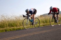 Two cyclists or road, racing downhill — Stock Photo