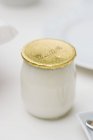 Yogurt in glass jar on table, healthy eating — Stock Photo