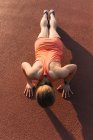 Young woman working out, doing press-ups, outdoors, elevated view — Stock Photo