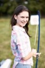 Portrait of teenage girl practicing archery — Stock Photo