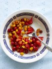 Still life with bowl of pickled chillies — Stock Photo