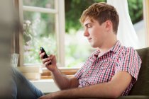 Young man using smartphone — Stock Photo