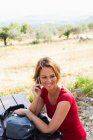 Жінка сидить на лавці для пікніка на мобільний телефон — стокове фото
