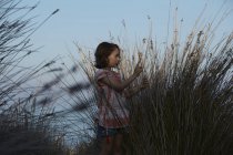 Girl and silhouetted long grass, Almeria, Andalusia, Spain — Stock Photo