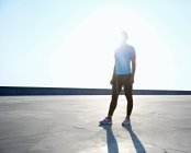Runner standing on rooftop at daytime — Stock Photo