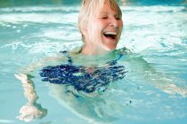 Older woman swimming in pool — Stock Photo