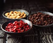Bowls of dried fruit and nuts, close up — Stock Photo