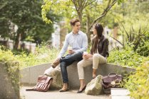 Young businessman and woman meeting in city park — Stock Photo
