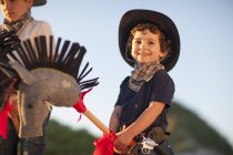 Two brothers dressed as cowboys on hobby horses — Stock Photo