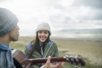 Young man playing guitar, Brean Sands, Somerset, England — Stock Photo