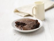 Hot chocolate fudge pudding on white washed wood — Stock Photo