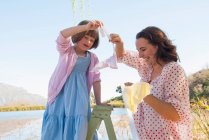 Mother and daughter hanging bunting — Stock Photo