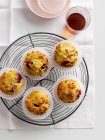 Fruit muffins on cooling rack — Stock Photo