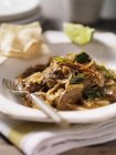 Ciotola di curry di agnello nero con cipolle e fetta di lime — Foto stock