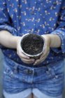 Close up of girl holding flower pot with seeds, cropped shot — Stock Photo