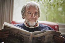 Älterer Mann liest Zeitung — Stockfoto