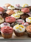 Decorated cupcakes on tray — Stock Photo