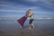 Portrait de couple embrassant sur le rivage de la mer — Photo de stock