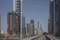Skyscrapers and metro rail tracks under blue sky — Stock Photo