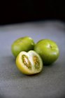 Close up of halved tomatillo and wholesome ones — Stock Photo