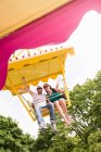 Couple riding amusement park ride — Stock Photo
