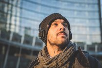 Low angle view of man in headphones looking away — Stock Photo