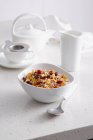 Bowl of granola on breakfast table — Stock Photo