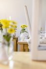 Flowers and chairs on tables in closed cafe — Stock Photo