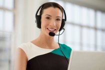 Female telephonist wearing headset — Stock Photo