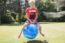 Boy jumping on space hopper — Stock Photo