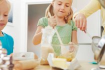 Children baking, mixing ingredients — Stock Photo