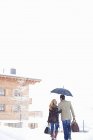 Couple walking together in snow — Stock Photo
