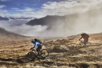 Mature men mountain biking, Valais, Switzerland — Stock Photo
