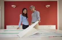 Two architects with blueprints in office — Stock Photo