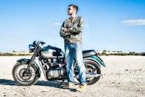 Portrait of young male motorcyclist on arid plain, Cagliari, Sardinia, Italy — Stock Photo