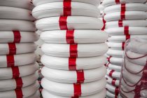 Stack of life buoys in factory that produces products for boating and camping — Stock Photo