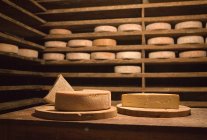 Stacks of cheese wheels — Stock Photo